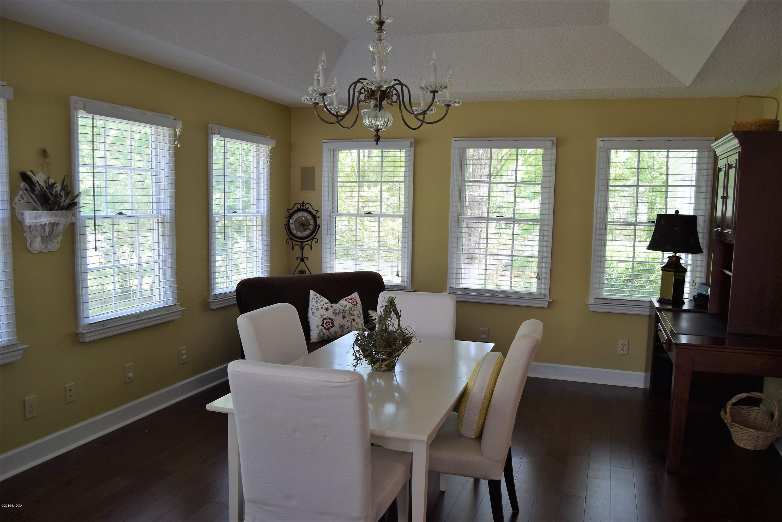 475 Stone Edge Road Macon, GA 31210 - Photo 15 of 36 a dining room with furniture a chandelier and wooden floor