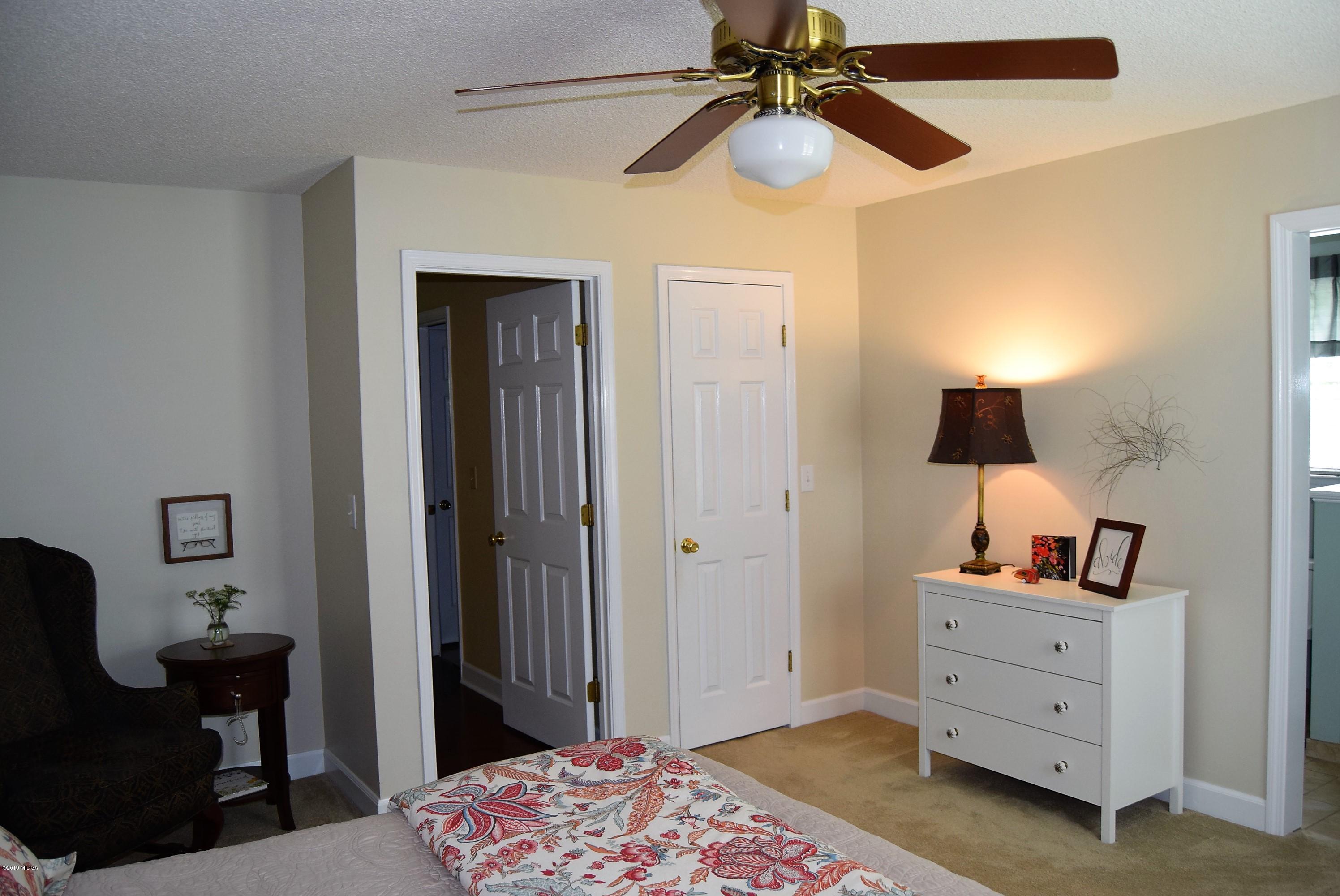 475 Stone Edge Road Macon, GA 31210 - Photo 18 of 36 a bedroom with a bed and a chandelier fan