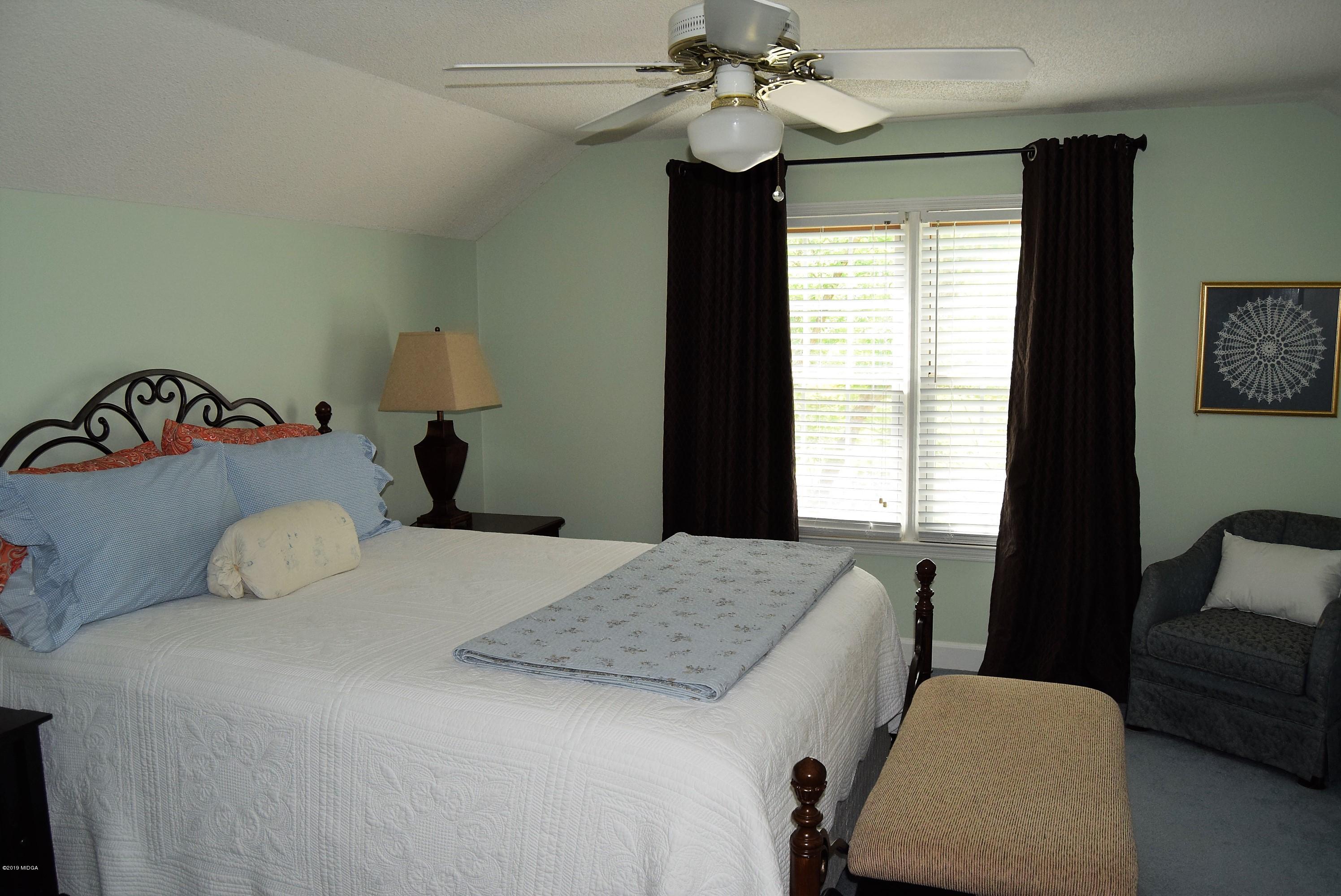 475 Stone Edge Road Macon, GA 31210 - Photo 20 of 36 a bedroom with a bed and a couch