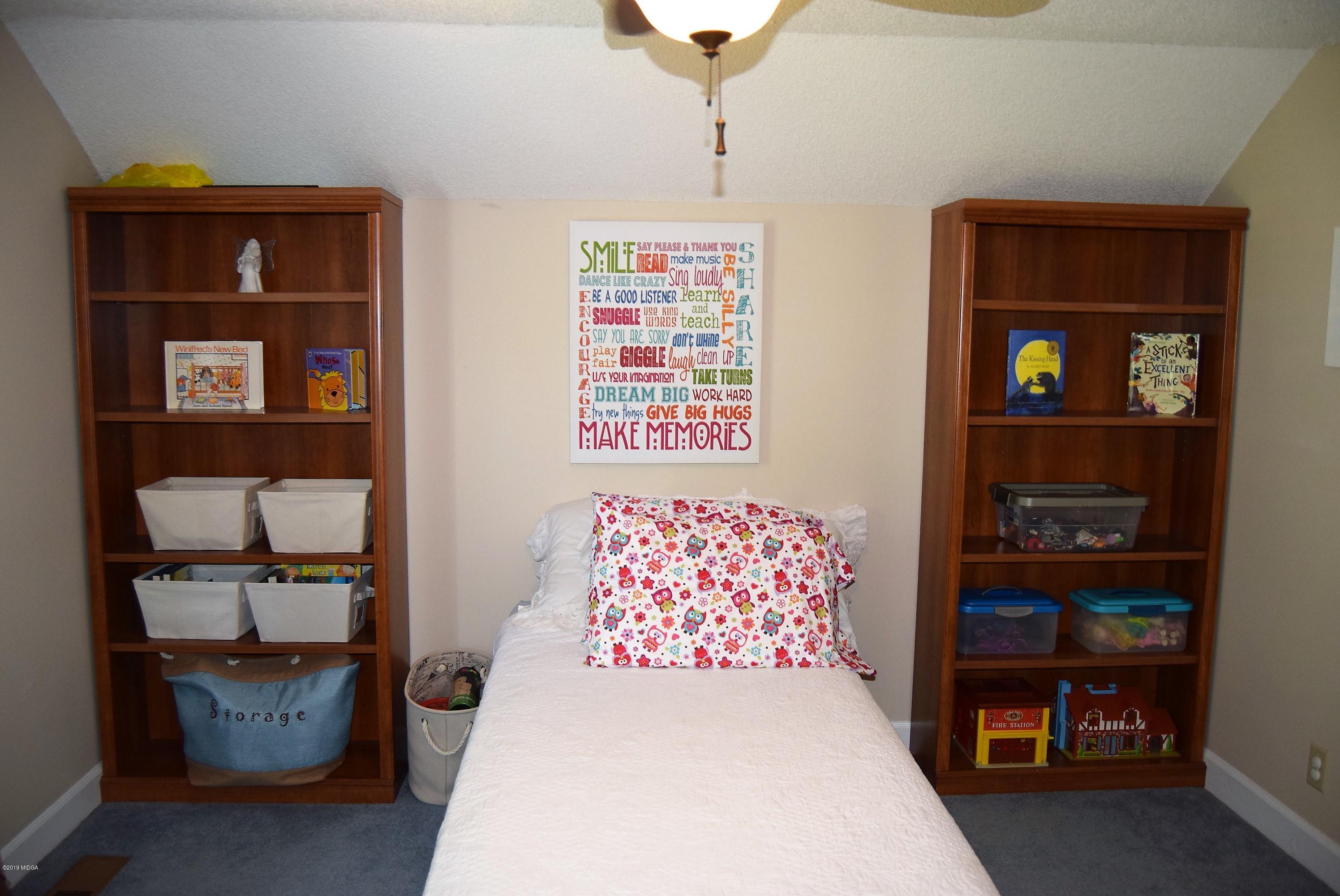 475 Stone Edge Road Macon, GA 31210 - Photo 23 of 36 a bedroom with a bed and a bookshelf