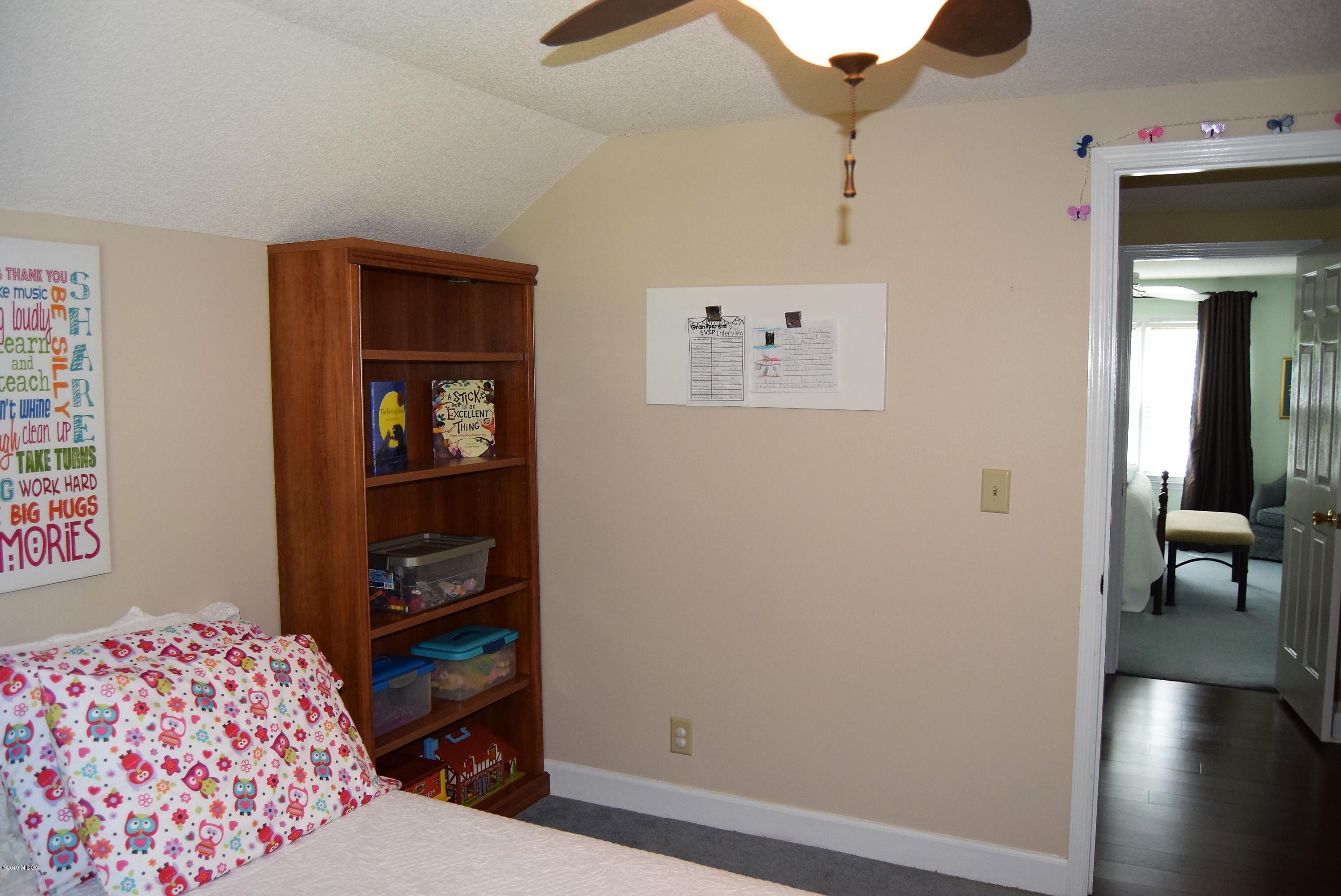 475 Stone Edge Road Macon, GA 31210 - Photo 25 of 36 a bedroom with a bed and a book shelf