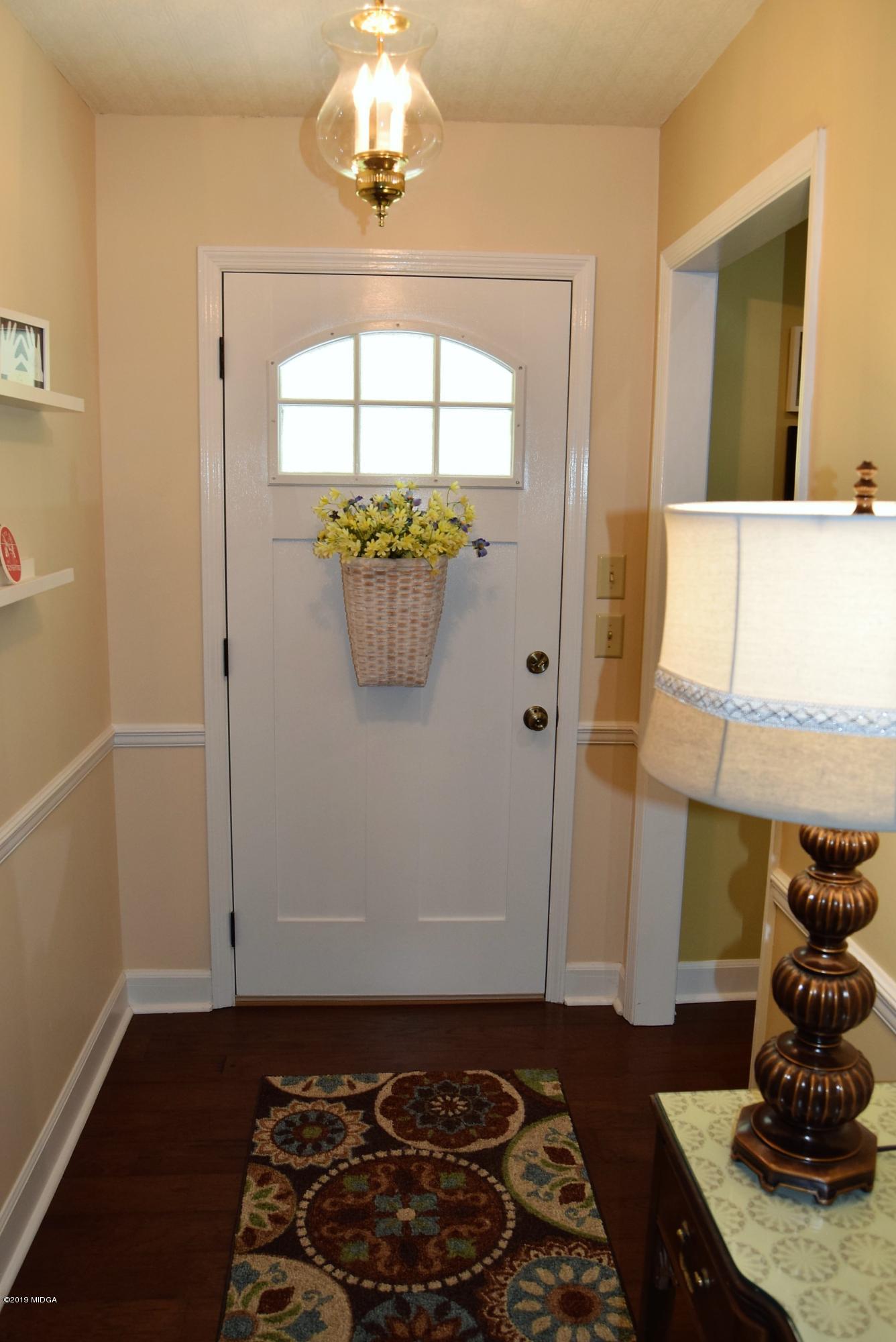 475 Stone Edge Road Macon, GA 31210 - Photo 4 of 36 a room with painting on the wall and a wooden floor
