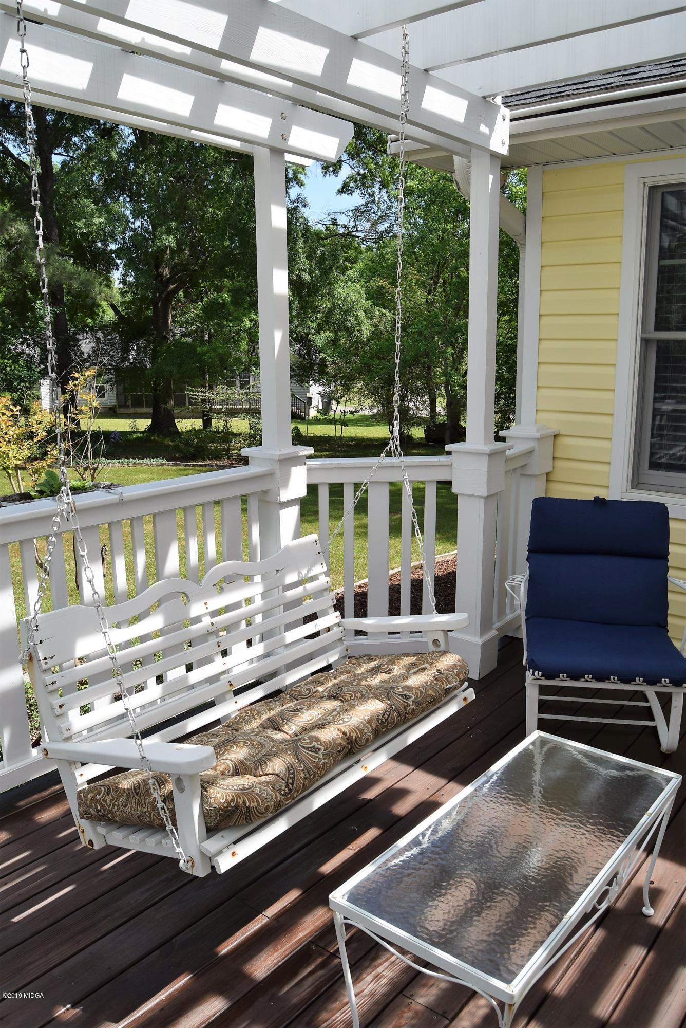 475 Stone Edge Road Macon, GA 31210 - Photo 32 of 36 a view of a patio with table and chairs potted plants with floor to ceiling window