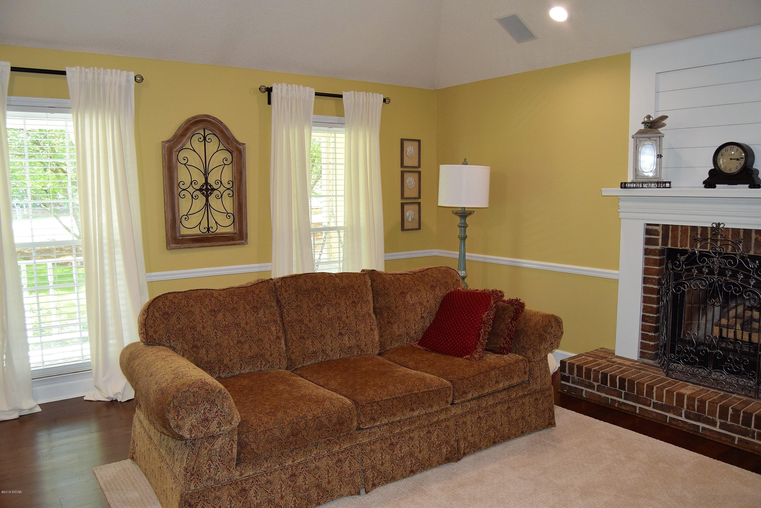 475 Stone Edge Road Macon, GA 31210 - Photo 7 of 36 a living room with furniture and a fireplace