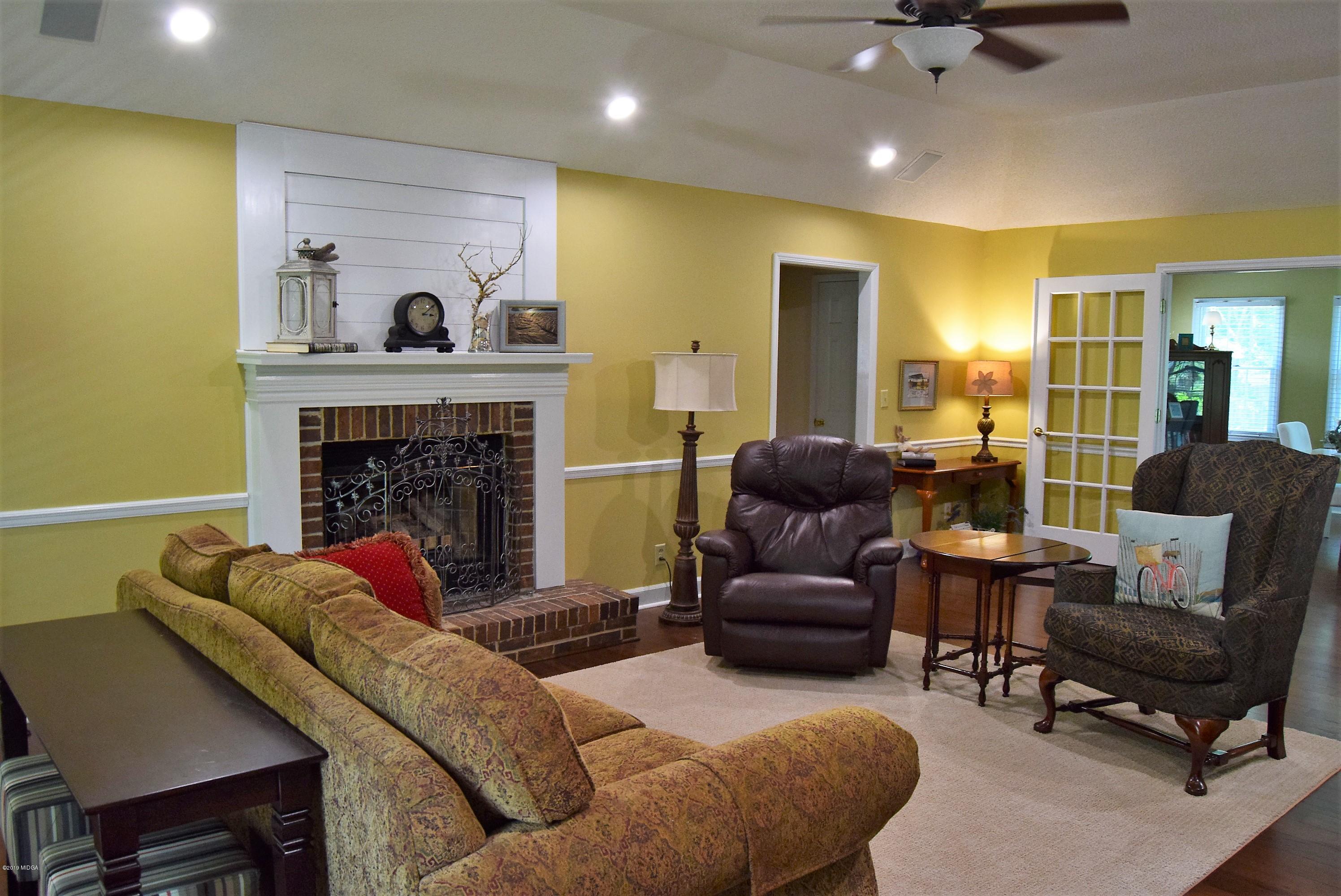 475 Stone Edge Road Macon, GA 31210 - Photo 8 of 36 a living room with furniture and a fireplace