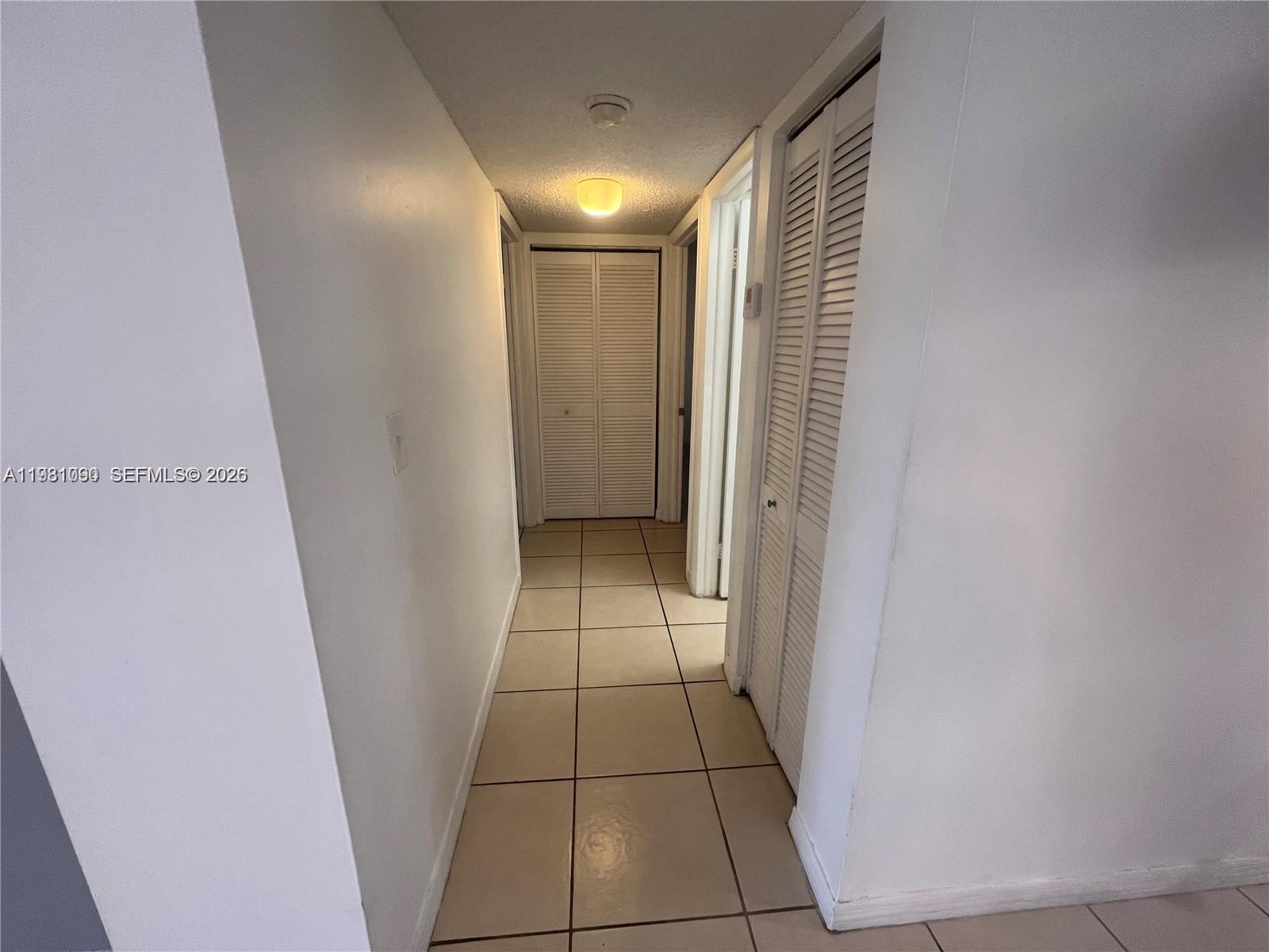 8500 Southwest 133rd Avenue Road, Unit 305 Miami, FL 33183 - Photo 4 of 7 a view of hallway with a window and a door
