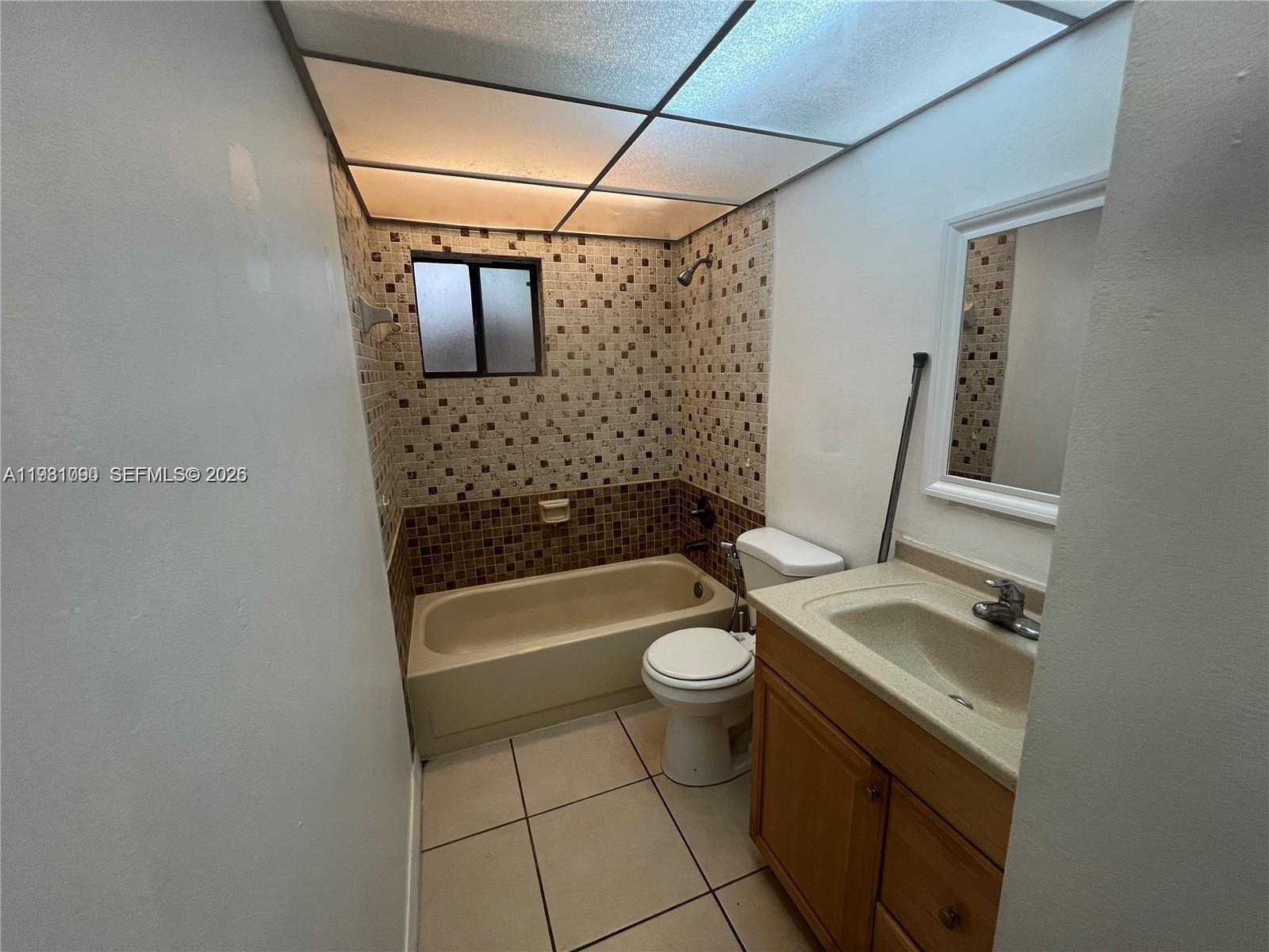 8500 Southwest 133rd Avenue Road, Unit 305 Miami, FL 33183 - Photo 6 of 7 a bathroom with a sink a toilet and bathtub