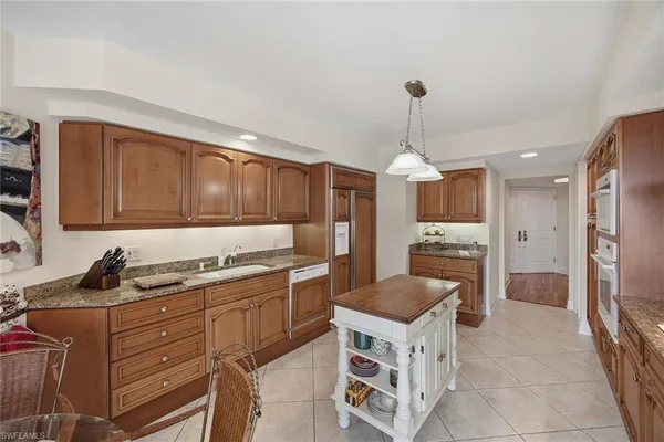 a kitchen with a stove top oven sink and cabinets