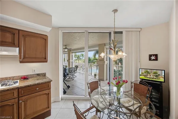 a view of a dining room with furniture and chandelier