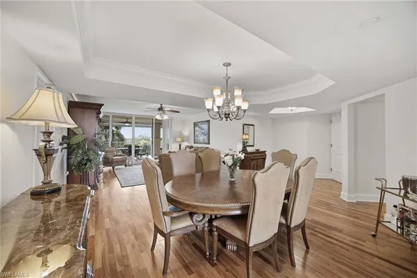 a living room with furniture a table and a large window