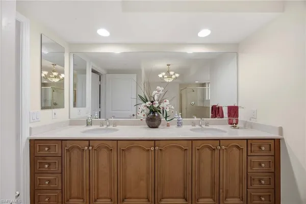 a bedroom with two beds and a chandelier