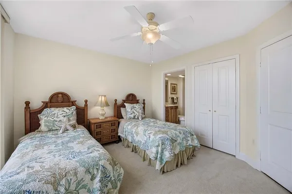 a spacious bedroom with two bed and a large window