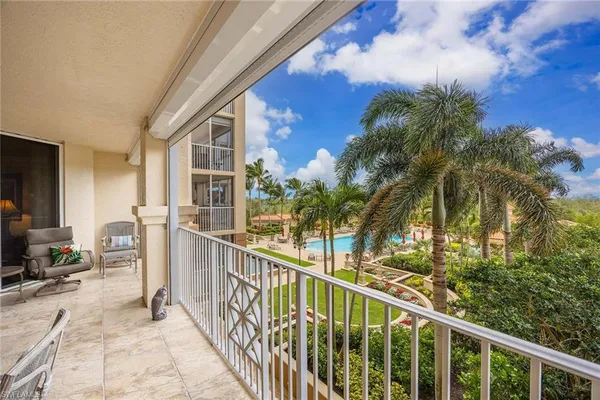 a dining room with furniture a chandelier and window