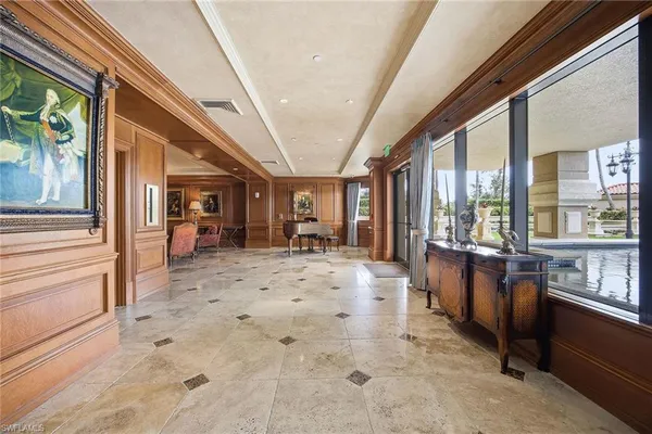 a living room with furniture chandelier and a view of kitchen