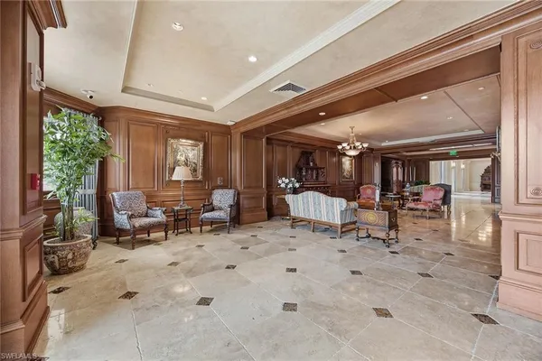 a living room with furniture a rug and a book shelf