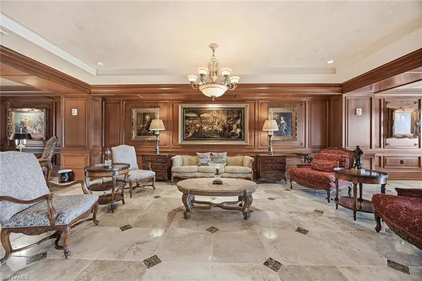 a living room with furniture a window and a flat screen tv
