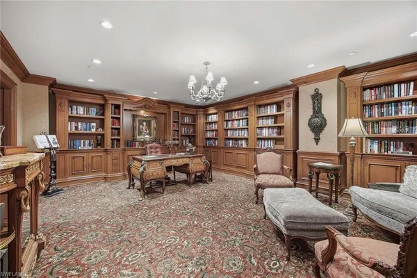 a room with furniture pool table and flat screen tv