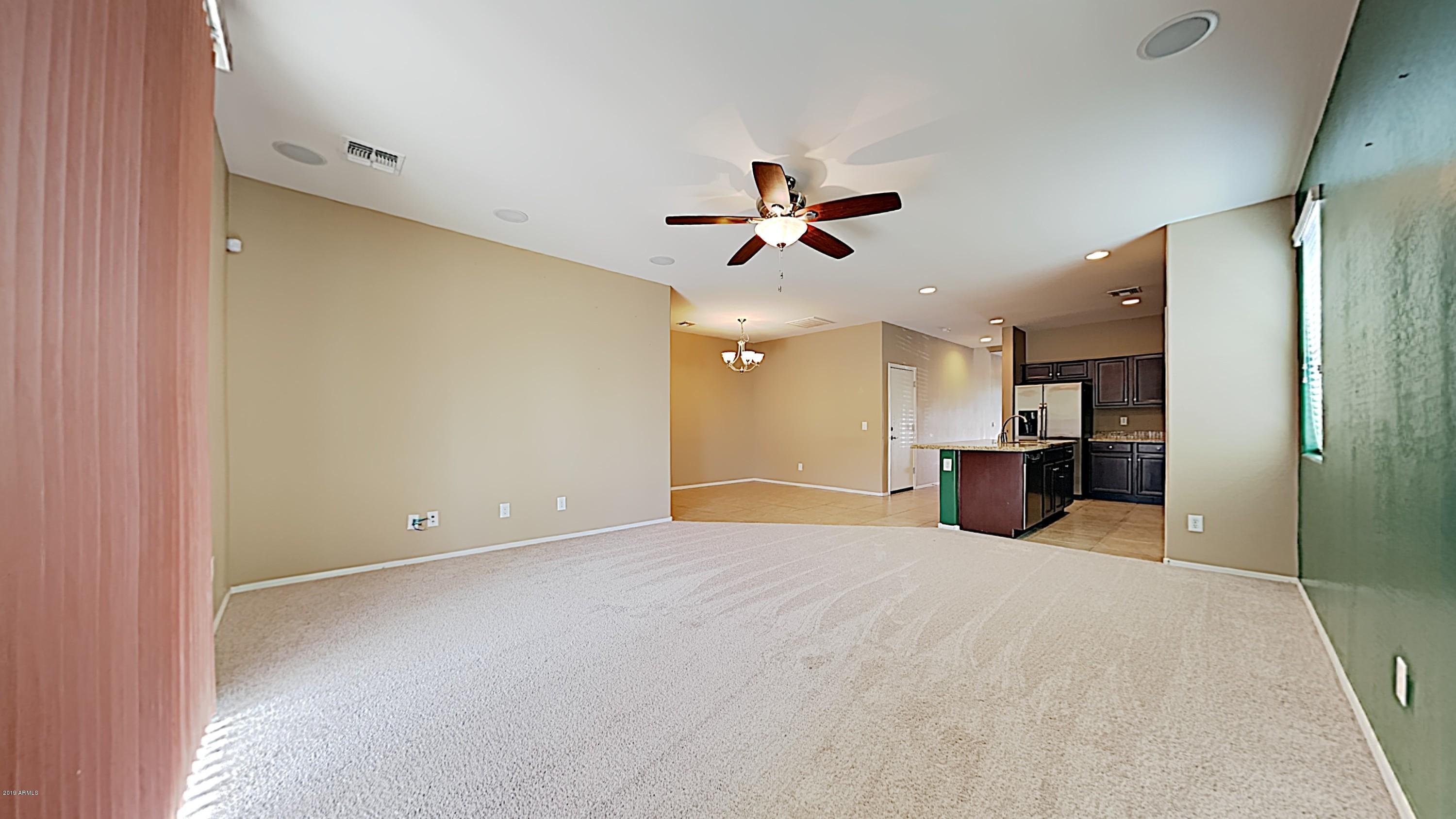 2633 West Gaby Road Phoenix, AZ 85041 - Photo 8 of 17 a view of a big room with closet and a ceiling fan
