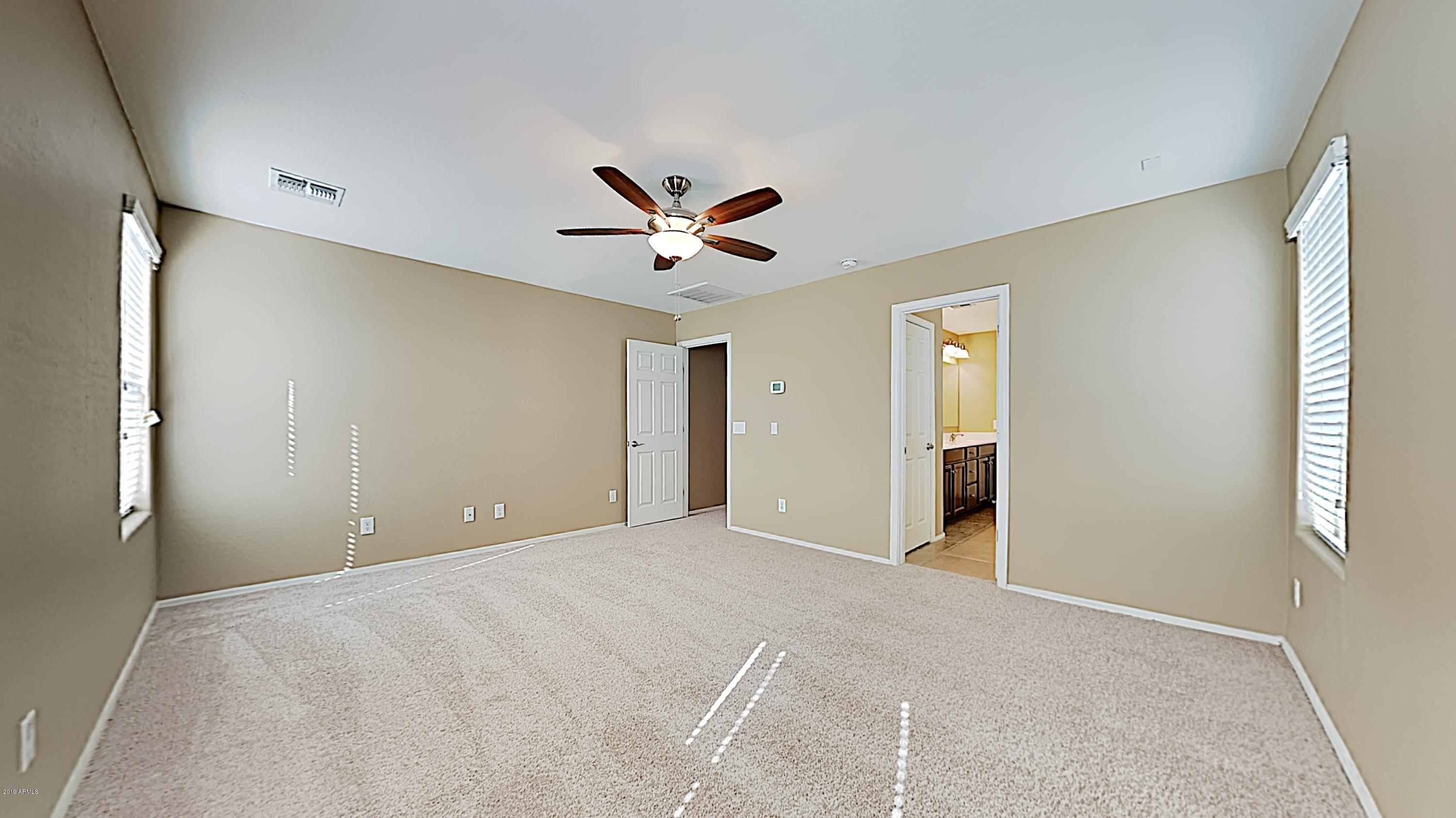 2633 West Gaby Road Phoenix, AZ 85041 - Photo 9 of 17 a view of an empty room with a window