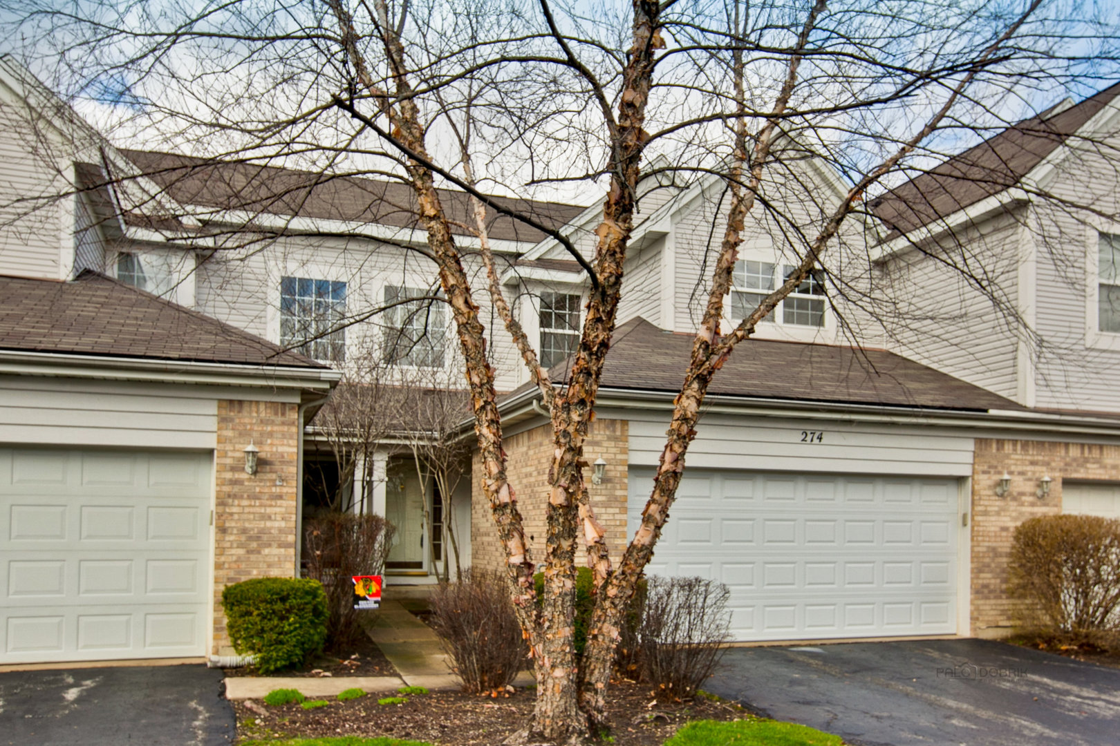 a view of a house with a tree