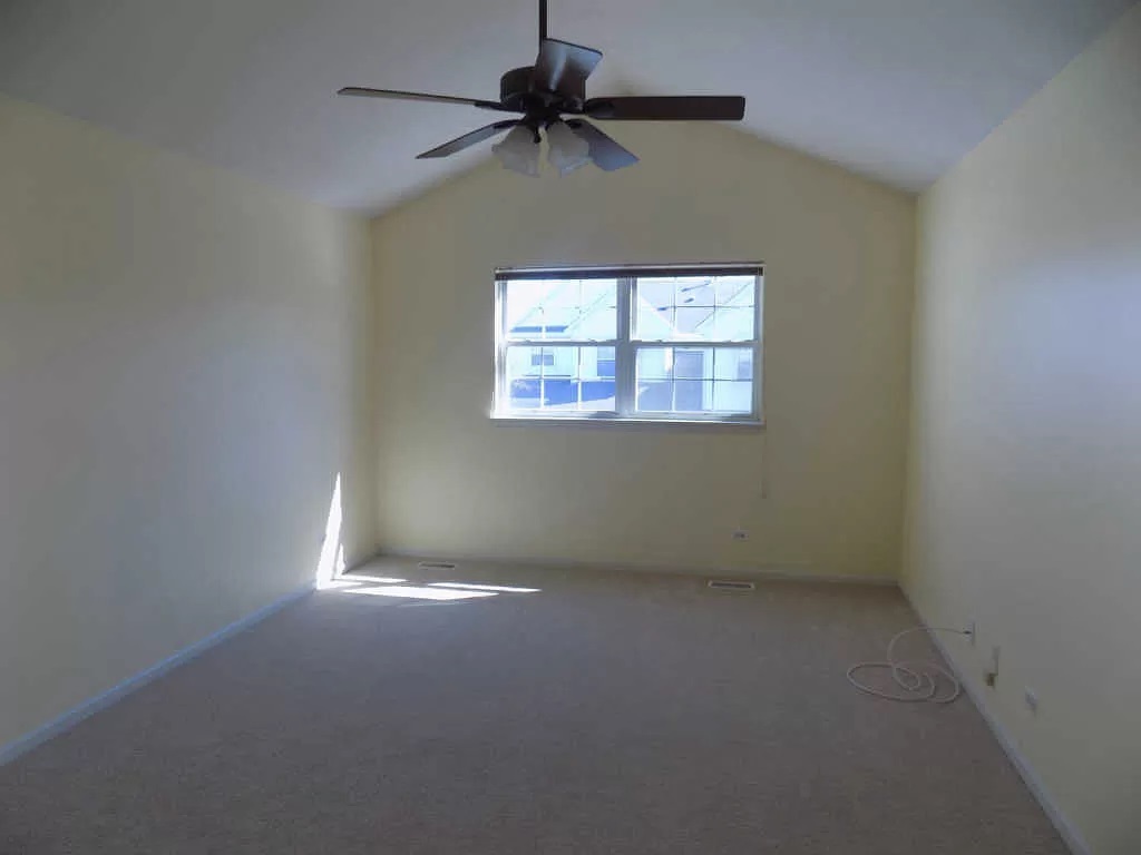 274 Bay Drive Itasca, IL 60143 - Photo 22 of 30 an empty room with a window and a fan