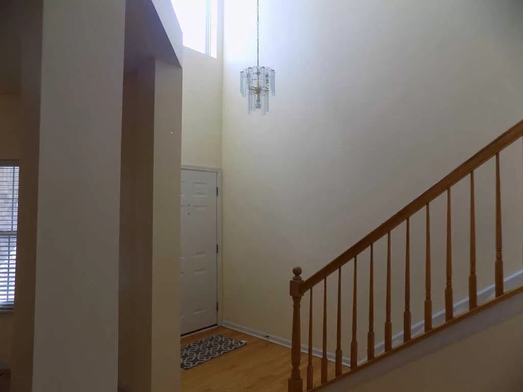 274 Bay Drive Itasca, IL 60143 - Photo 5 of 30 a view of staircase with railing and a chandelier