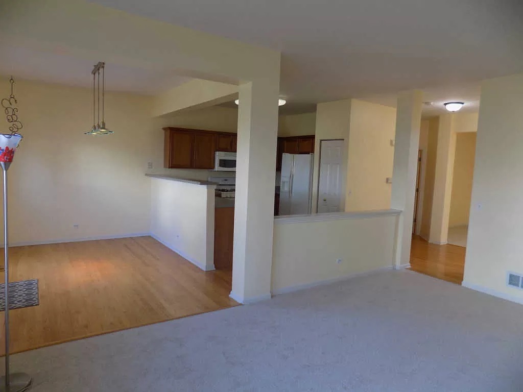 274 Bay Drive Itasca, IL 60143 - Photo 8 of 30 a view of hallway with stairs and a wooden floor