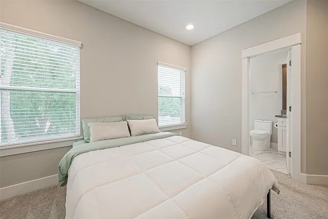 a bedroom with a large bed and a window