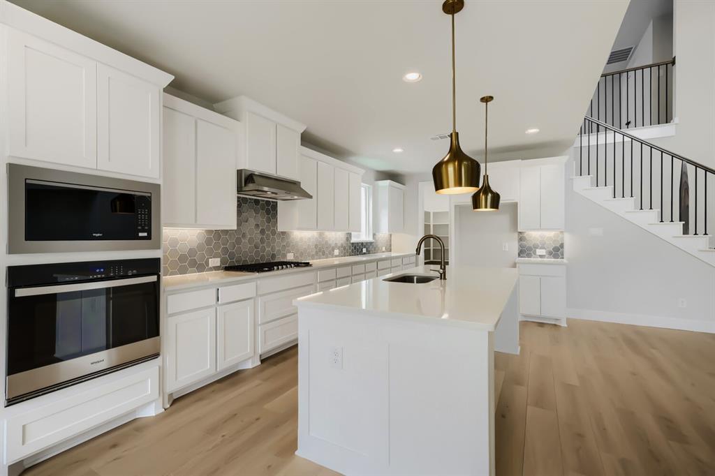 4414 Windy Point Road Oak Point, TX 75068 - Photo 7 of 27 a kitchen with sink cabinets and stainless steel appliances