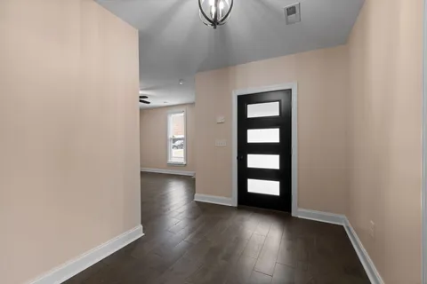 a kitchen with stainless steel appliances kitchen island granite countertop a refrigerator and a sink