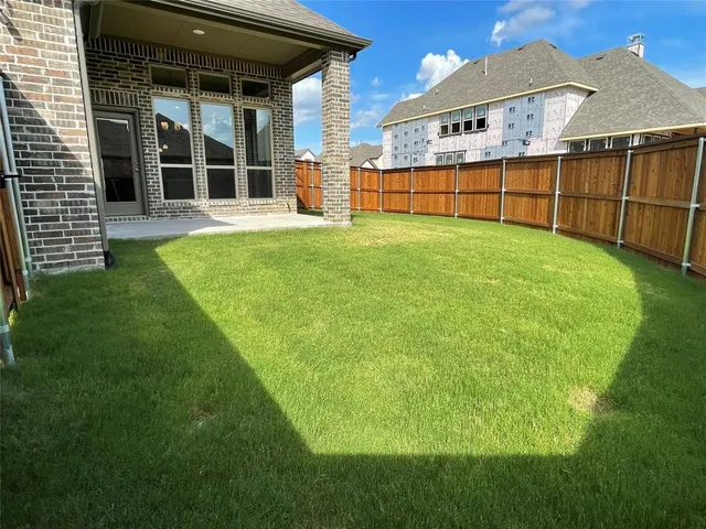 a view of a backyard with a garden and deck