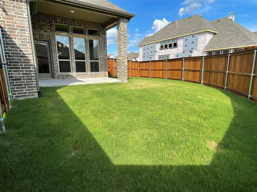 13969 Falcon Ranch Drive Frisco, TX 75035 - Photo 23 of 25 a view of a backyard with a garden and deck