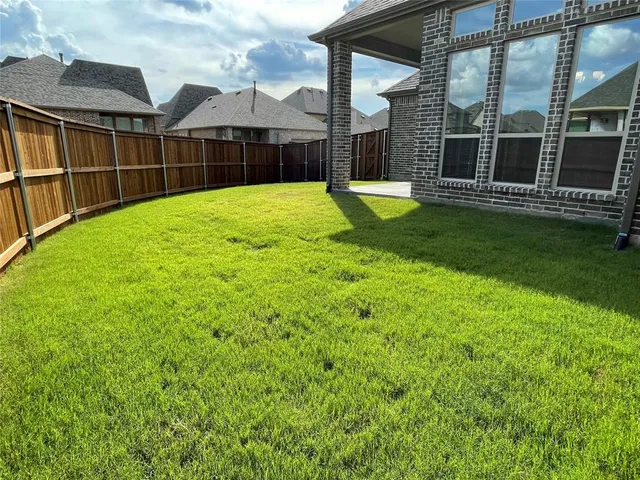 a view of a house with a yard and porch