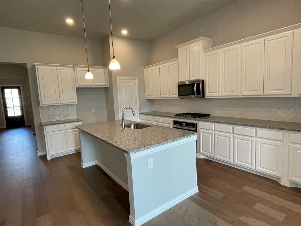 13969 Falcon Ranch Drive Frisco, TX 75035 - Photo 5 of 25 a kitchen with a sink stove top oven and cabinets