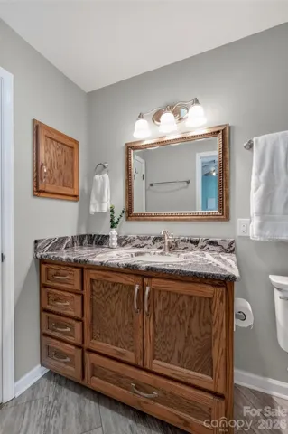 a view of a balcony with chairs and wooden floor