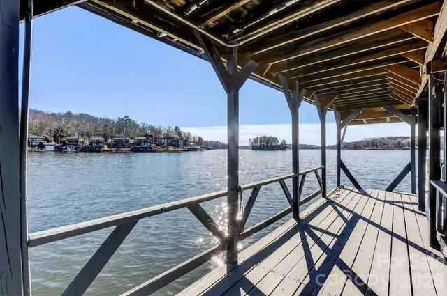a view of a livingroom with a floor to ceiling window and an entryway