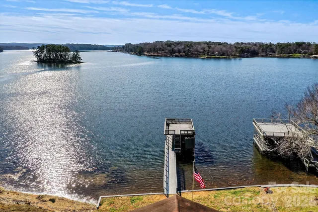 a kitchen with stainless steel appliances granite countertop a stove a sink dishwasher and a microwave oven with wooden floor