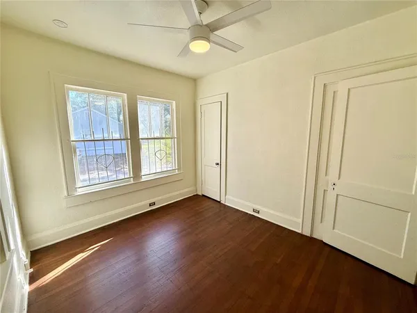 a view of an empty room with glass door and a window