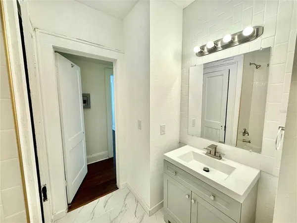 a bathroom with a sink a mirror and a shower