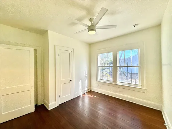wooden floor in an empty room with a window