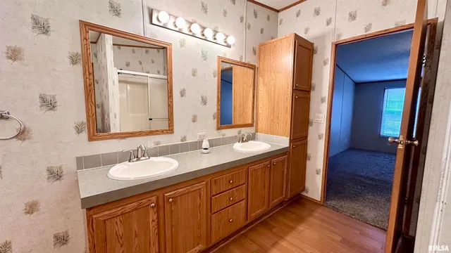 a spacious bathroom with a double vanity sink and a mirror