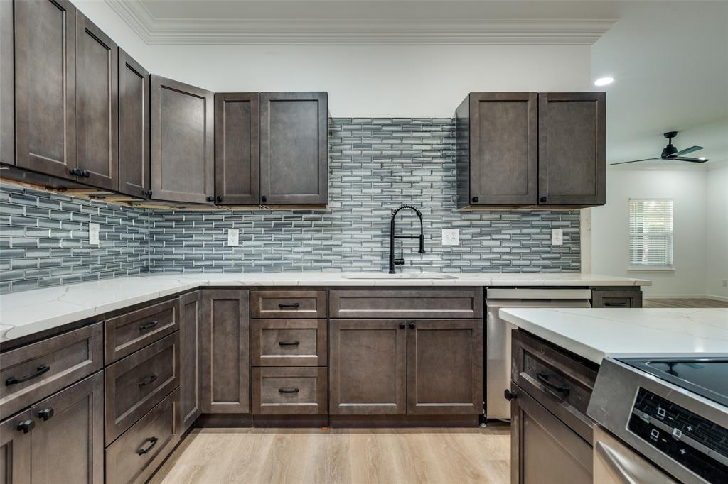 1727 Pear Street Dallas, TX 75215 - Photo 4 of 13 a kitchen with stainless steel appliances granite countertop a sink stove and cabinets