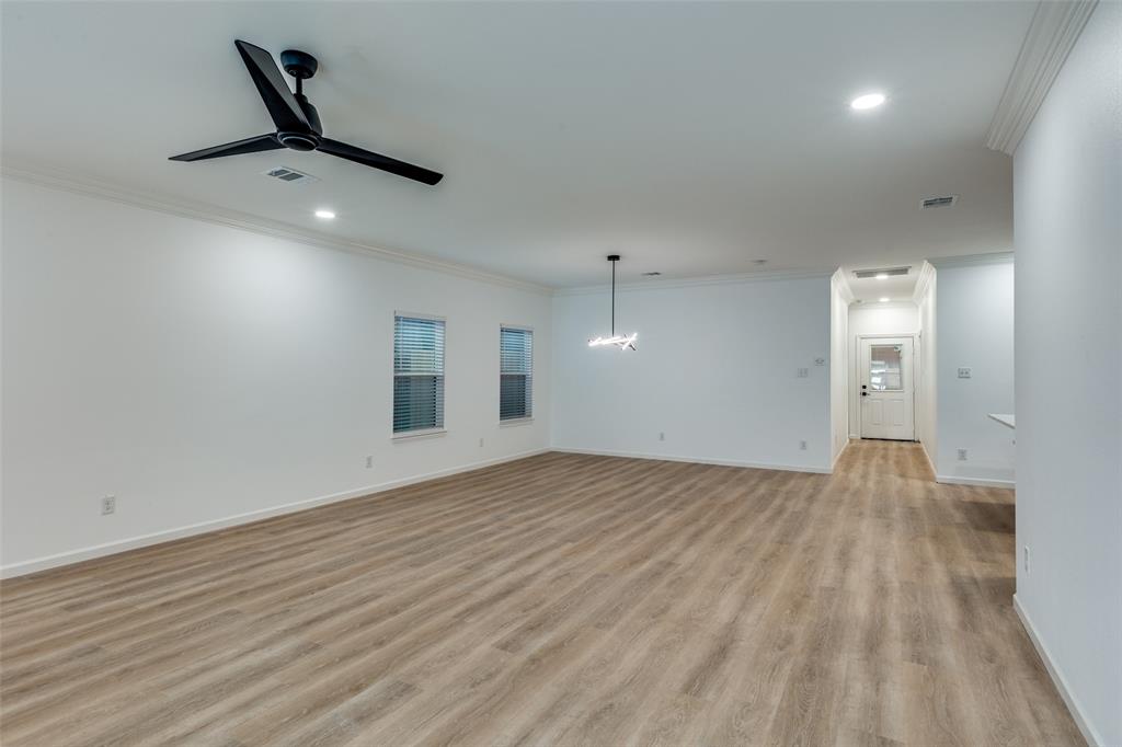 1727 Pear Street Dallas, TX 75215 - Photo 5 of 13 an empty room with wooden floor and windows