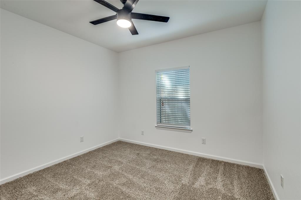 1727 Pear Street Dallas, TX 75215 - Photo 6 of 13 an empty room with a window and ceiling fan