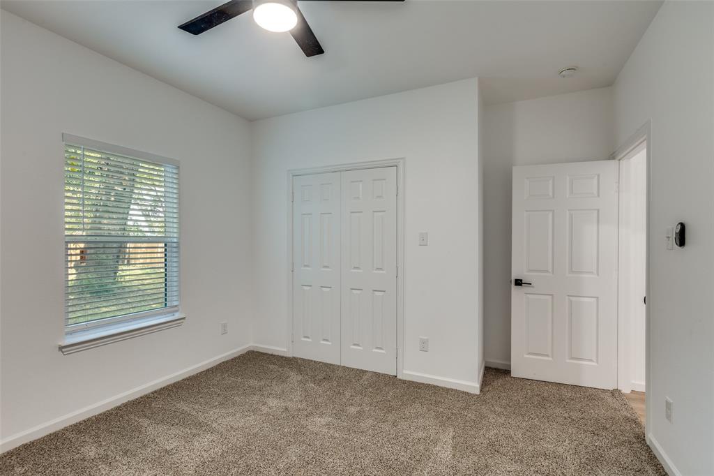 1727 Pear Street Dallas, TX 75215 - Photo 9 of 13 an empty room with chandelier fan and windows