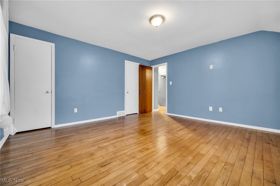 1605 Laclede Road Cleveland, OH 44121 - Photo 25 of 40 Unfurnished bedroom with wood-type flooring, baseboards, and visible vents