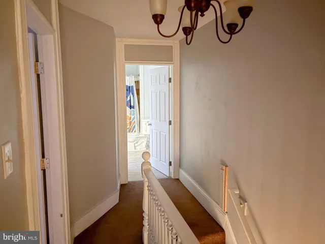 a hallway with front door wooden floor and windows