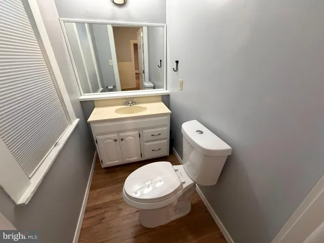 a bathroom with a toilet a sink and a mirror