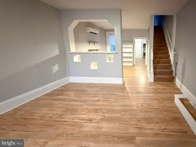 a view of a living room with wooden floor