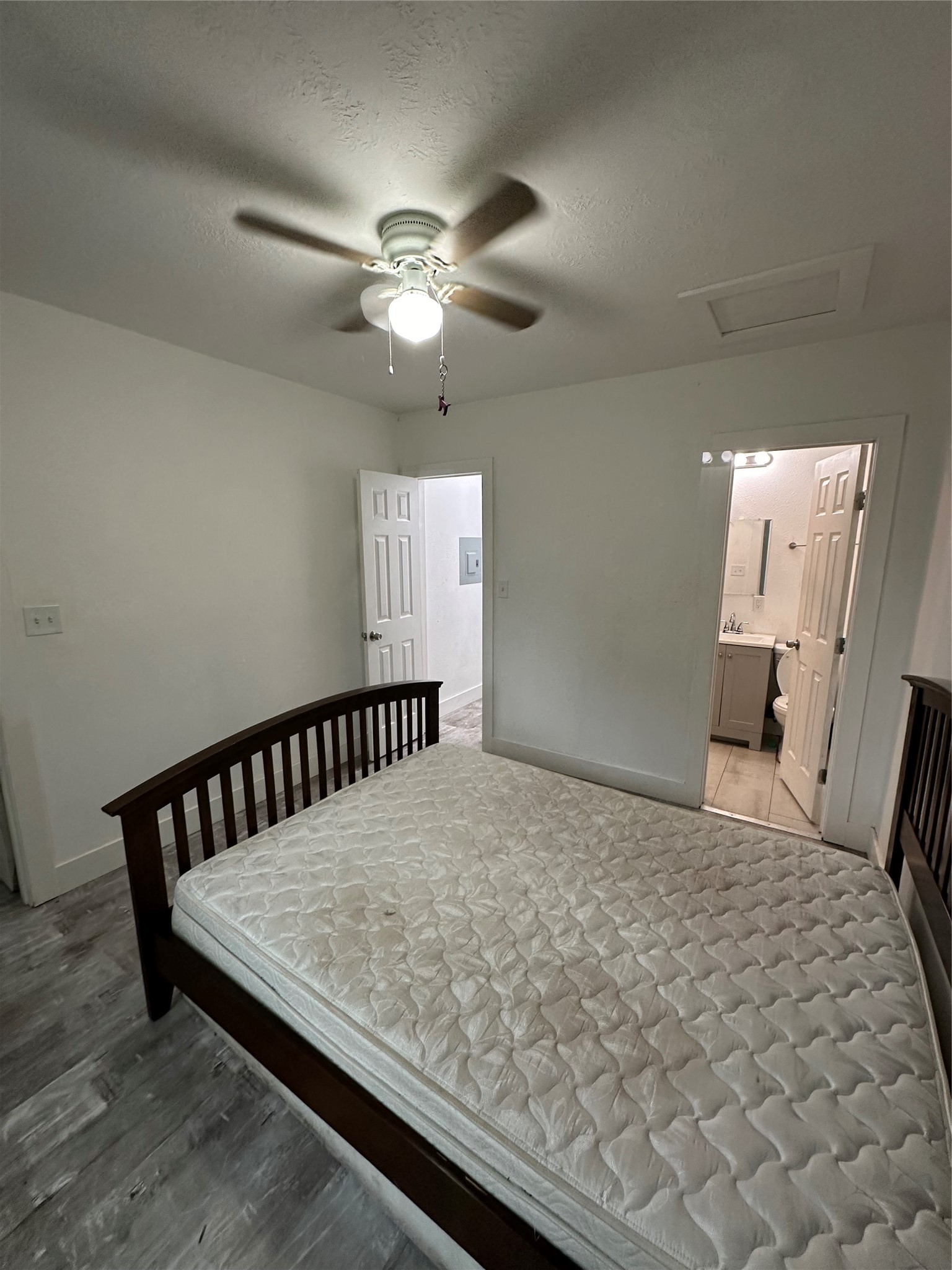 1405 Miles Street Houston, TX 77015 - Photo 5 of 9 a bedroom with a bed and wooden floor